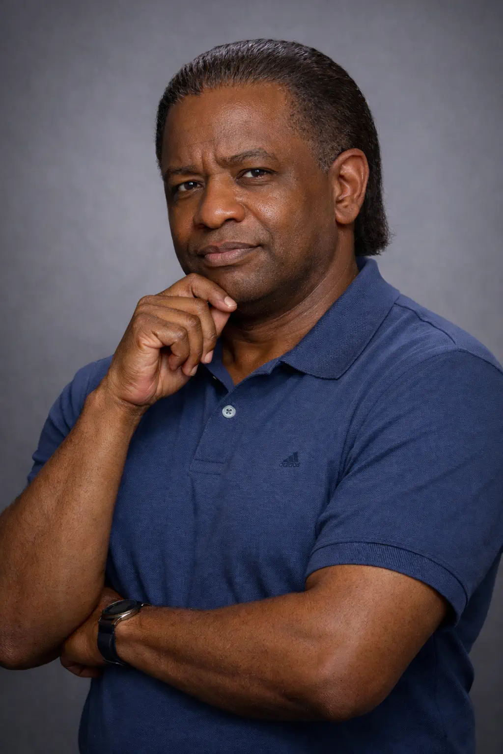 Portrait of Bart Crenshaw in a blue polo shirt, posed with a thoughtful expression.